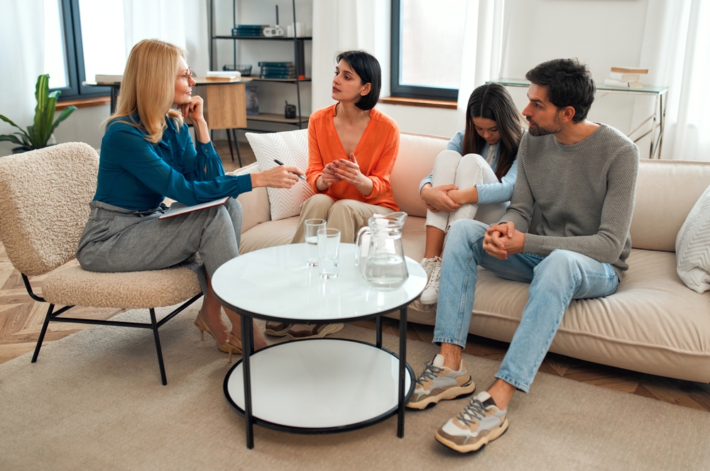 Upset,Teenager,Girl,With,Her,Parents,At,A,Psychologist's,Appointment.