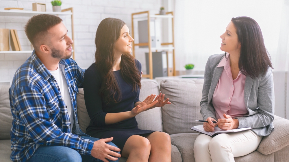 A,Couple,Sits,On,A,Couch,In,A,Therapists,Office